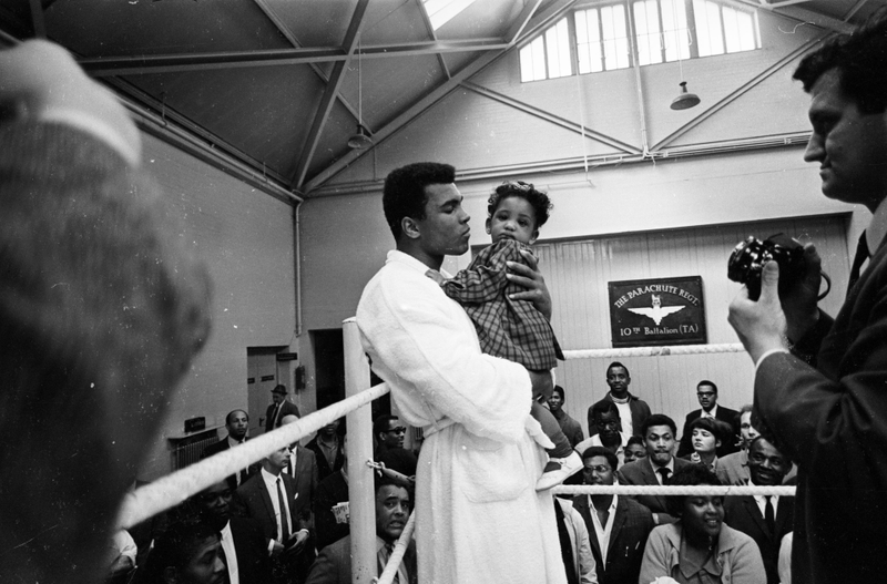 17th May 1966: World heavyweight boxing champion Muhammad Ali meets 8 month old Maria Morin in a training session at the Territorial Army Gymnasium at White City, London. Ali is in training for his fight against the British champion Henry Cooper at Arsenal's Highbury Stadium, London on May 21st. R. McPhedran/Express/Getty Images